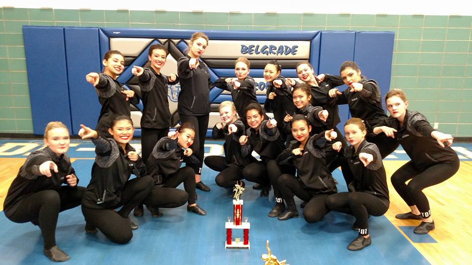 Varsity dance team with trophy