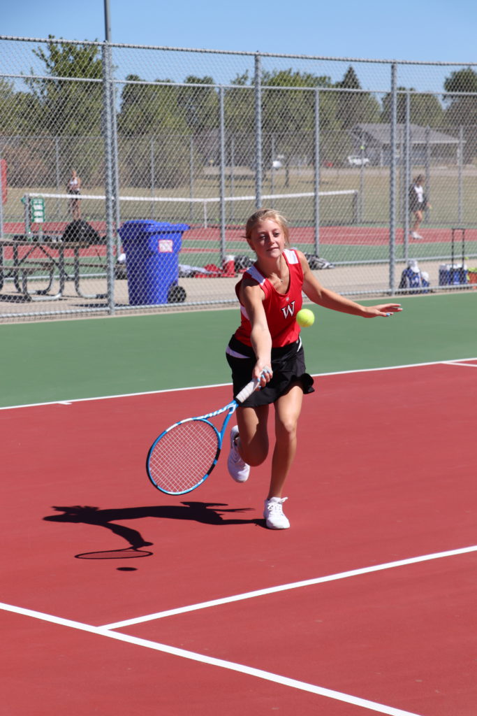 Trojan tennis player going for the tennis ball