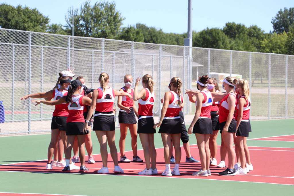 Trojan tennis team doing high fives