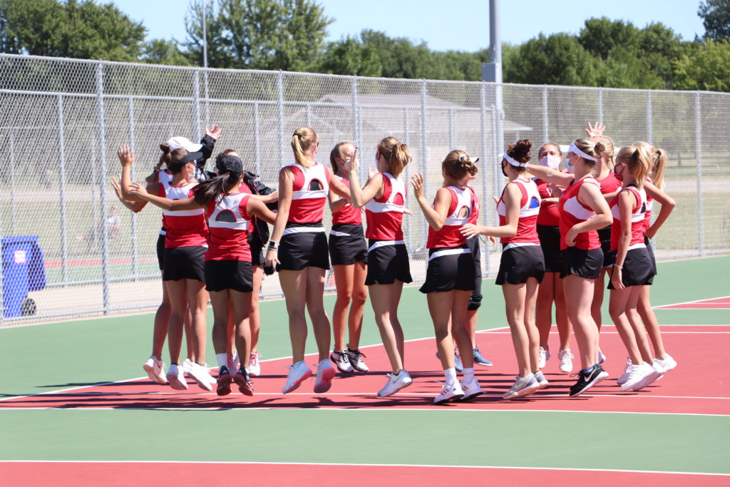 Trojan tennis team doing high fives