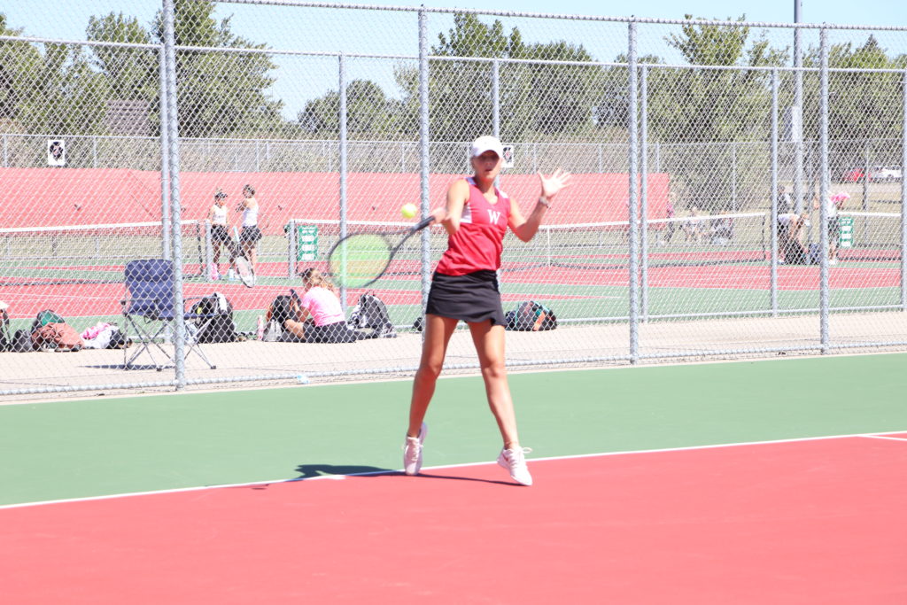 Trojan tennis player swinging