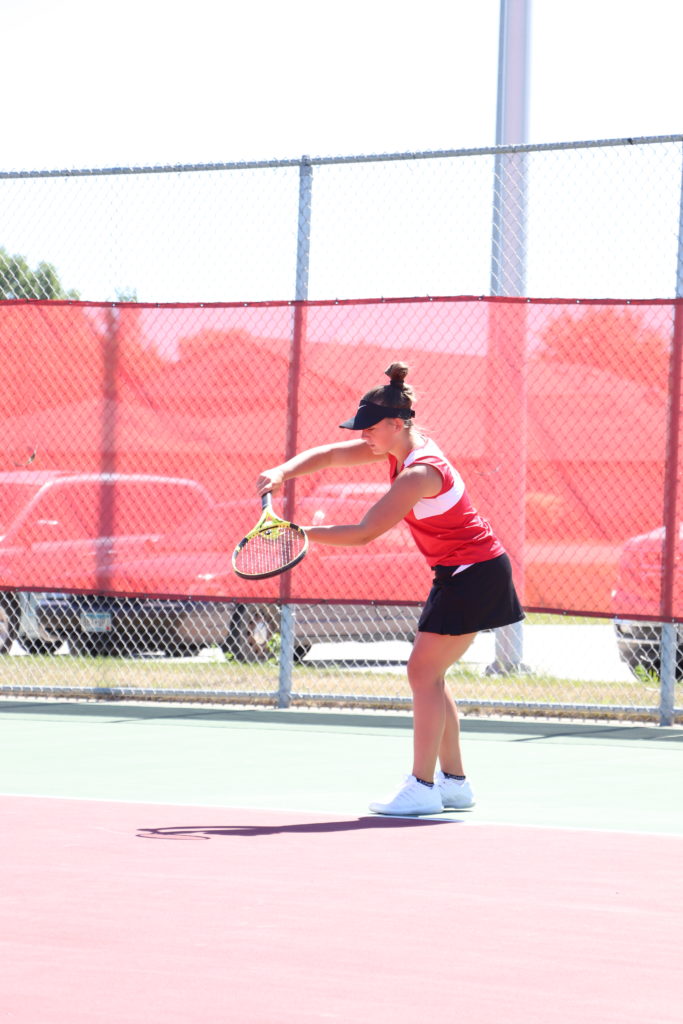 Trojan tennis player swinging