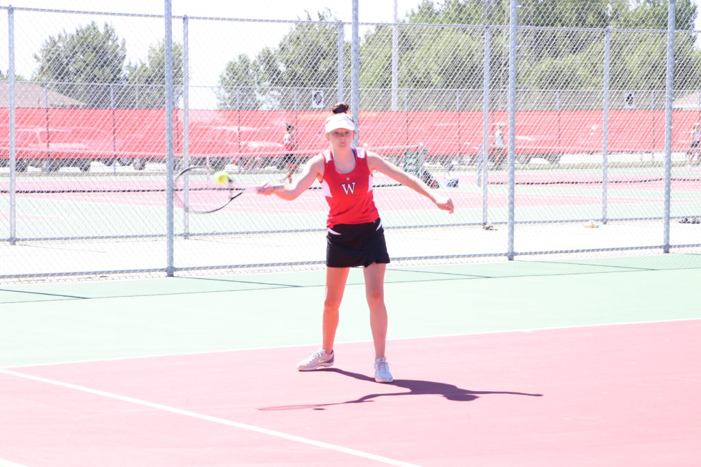 Trojan tennis player swinging