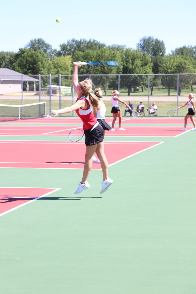 Trojan tennis player swinging