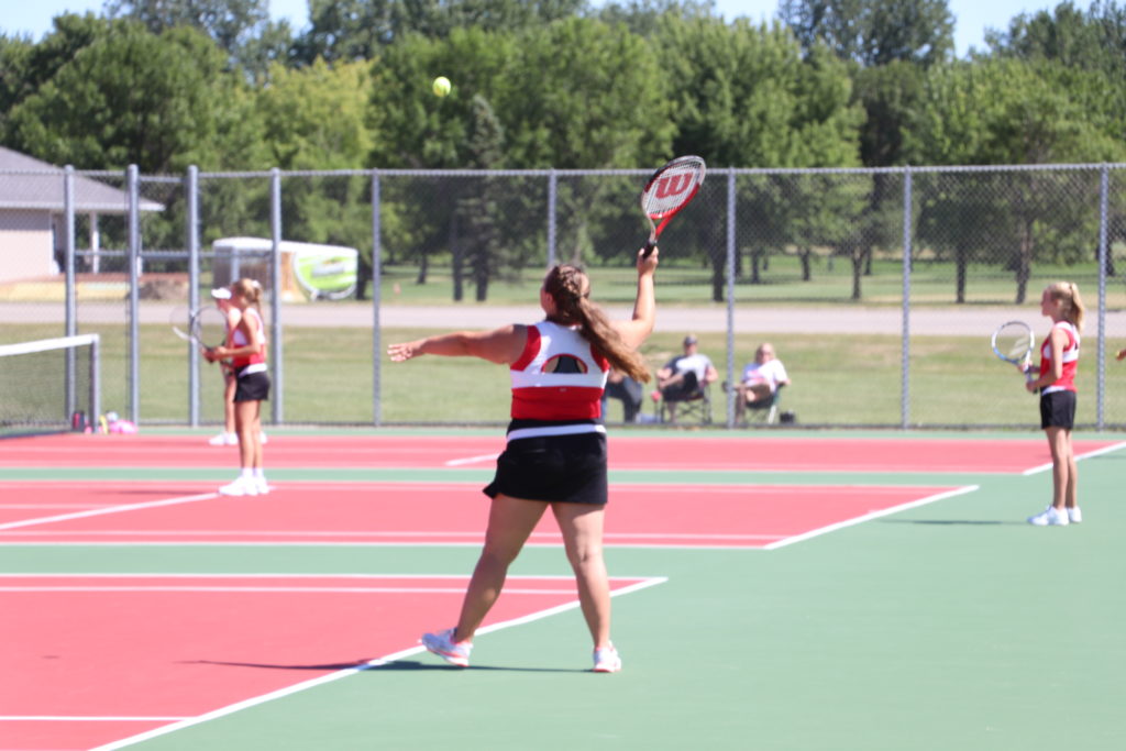 Trojan tennis player swinging