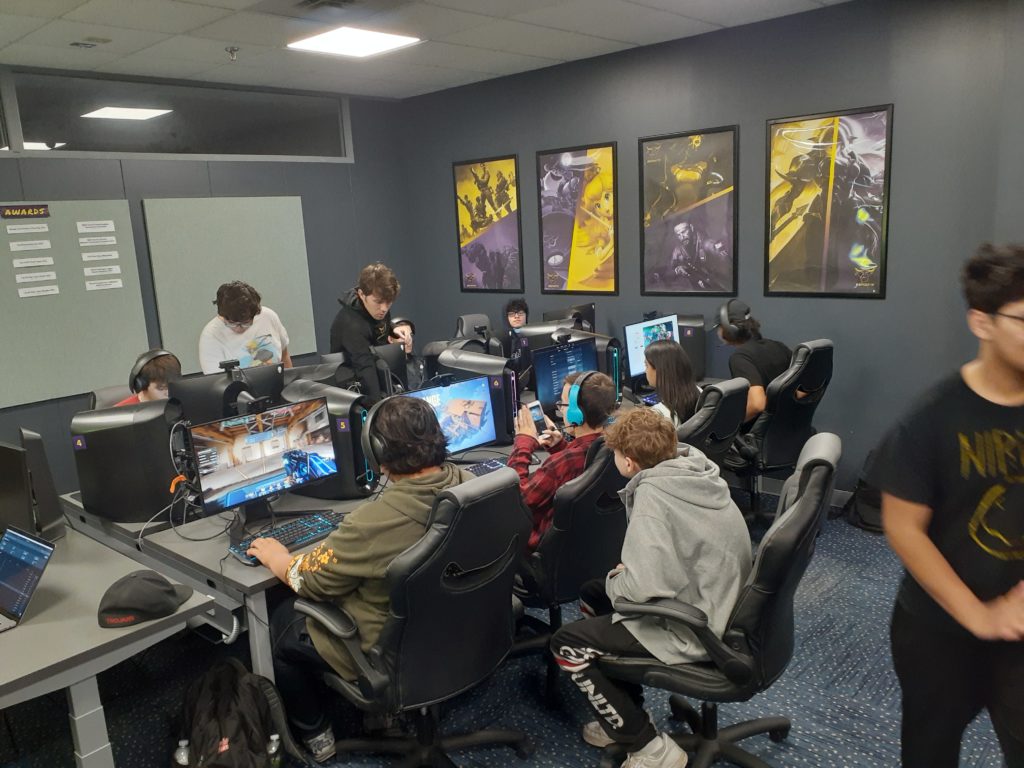 Students sitting in computer lab competing in video game