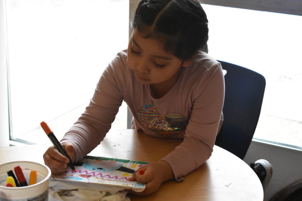 Girl coloring her t-shirt