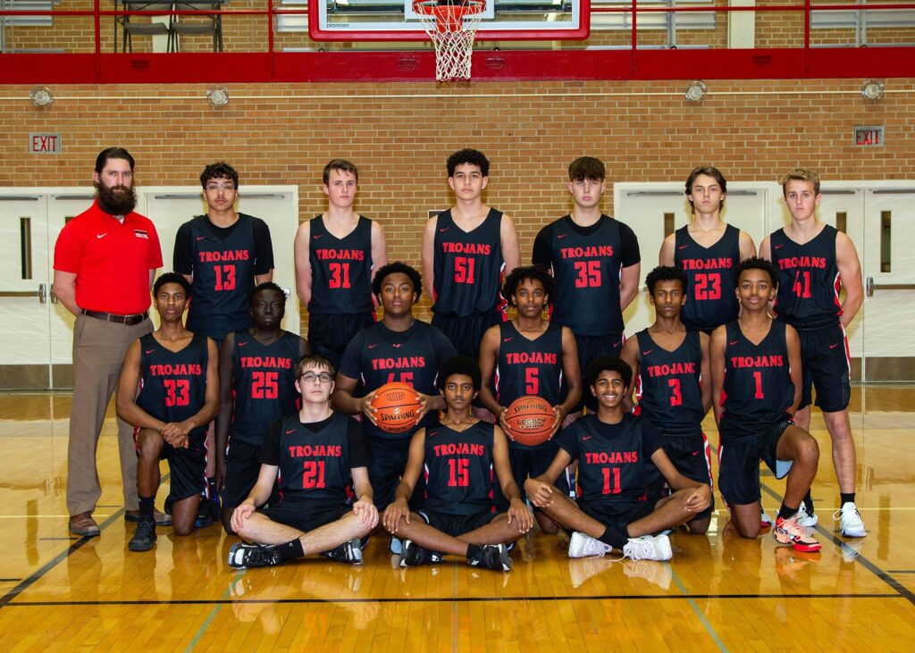 15 student basketball players with coach