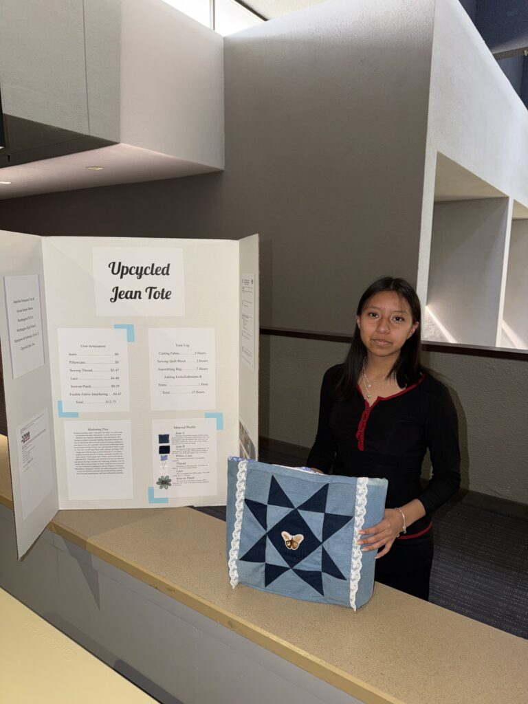 Student with display board and jean tote